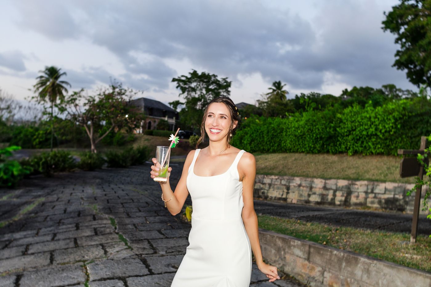Tropical garden wedding venue with stone pathway and palm trees.
