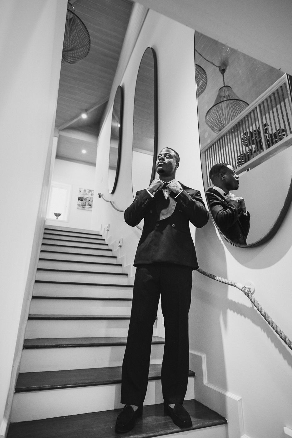 Black and white photos of formal event preparations on an elegant staircase.
