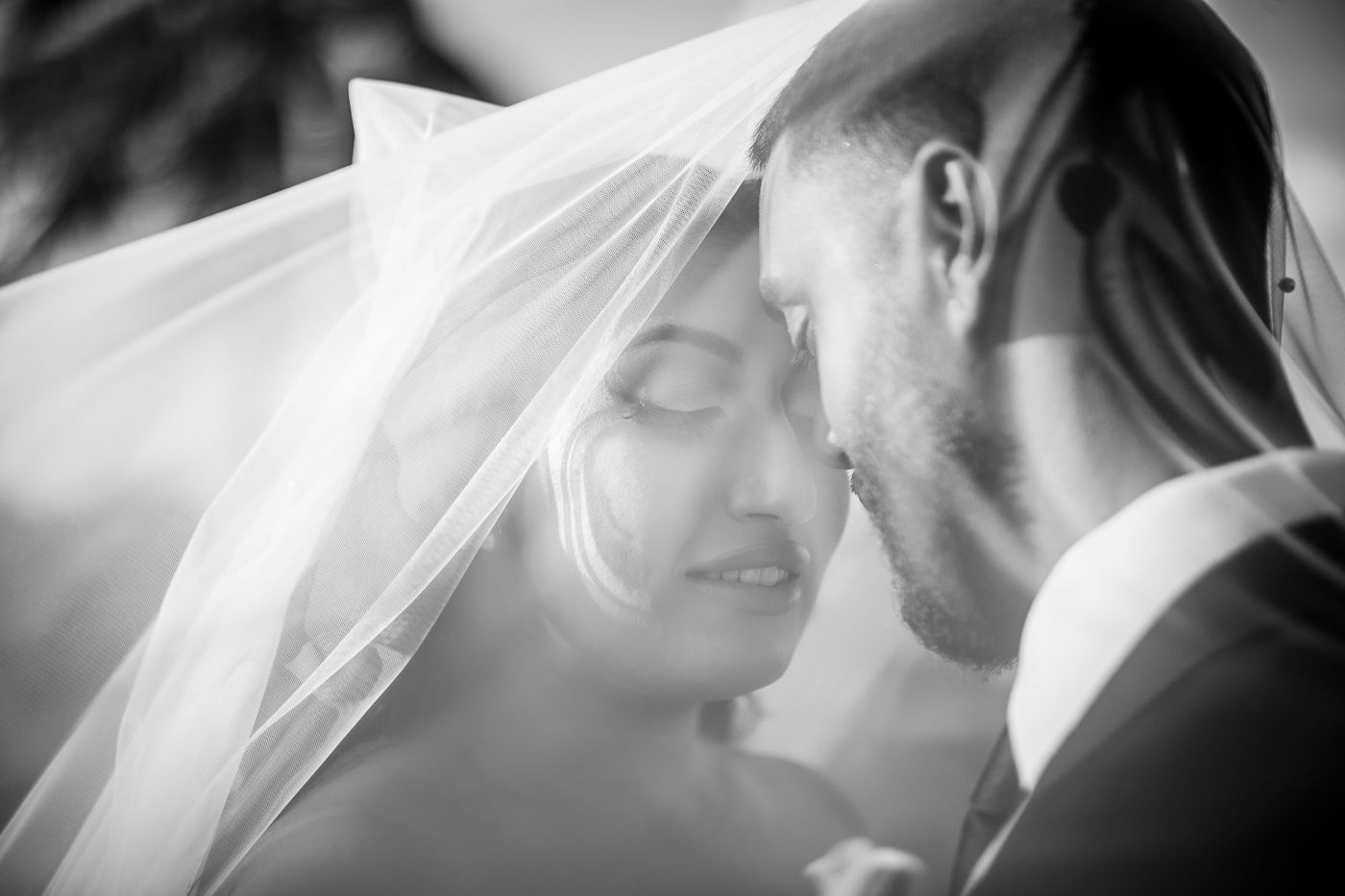 Black and white romantic wedding portraits with soft veil details.