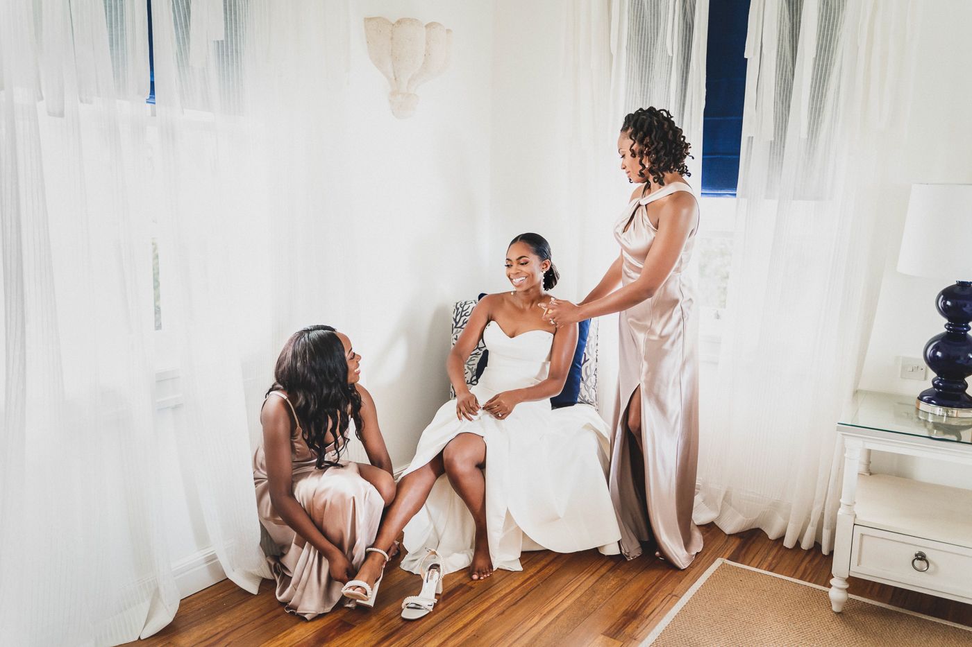 Wedding preparation scene with white draping and elegant formal attire.