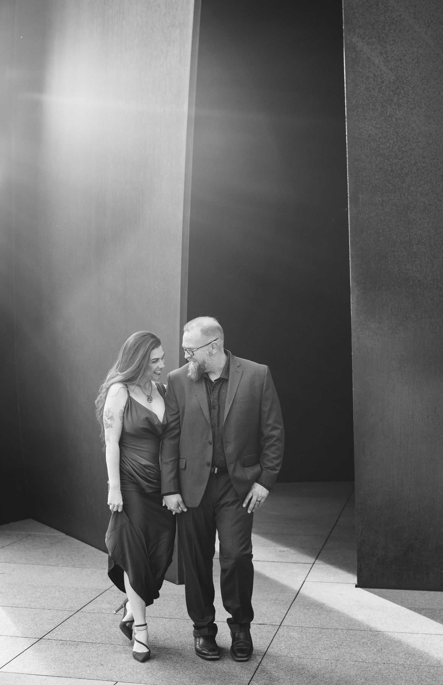 Married couple walking hand in hand at The Modern Art Museum in Fort Worth, museum engagement session, best photographer in Fort Worth