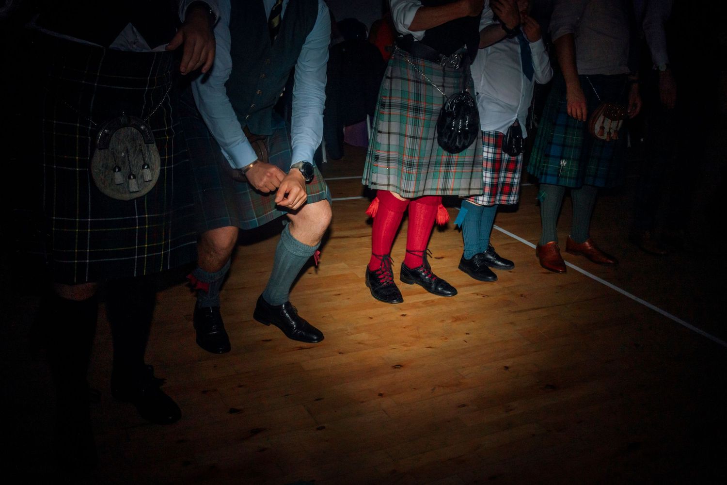 Scottish country dancing with guests during a wedding celebration party