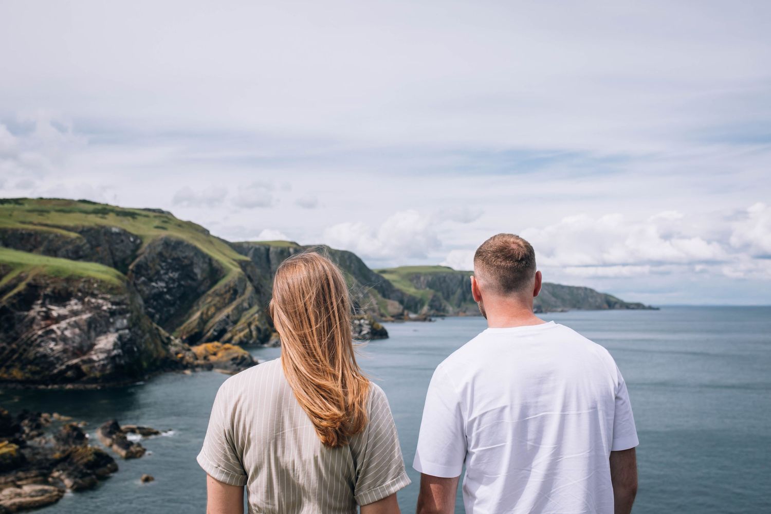 couple standing on cliffs during Scotland elopement
