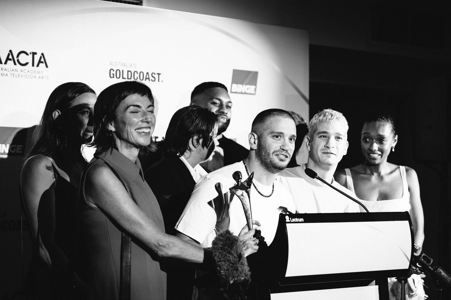 Black and white photo of attendees posing at the AACTA awards ceremony.