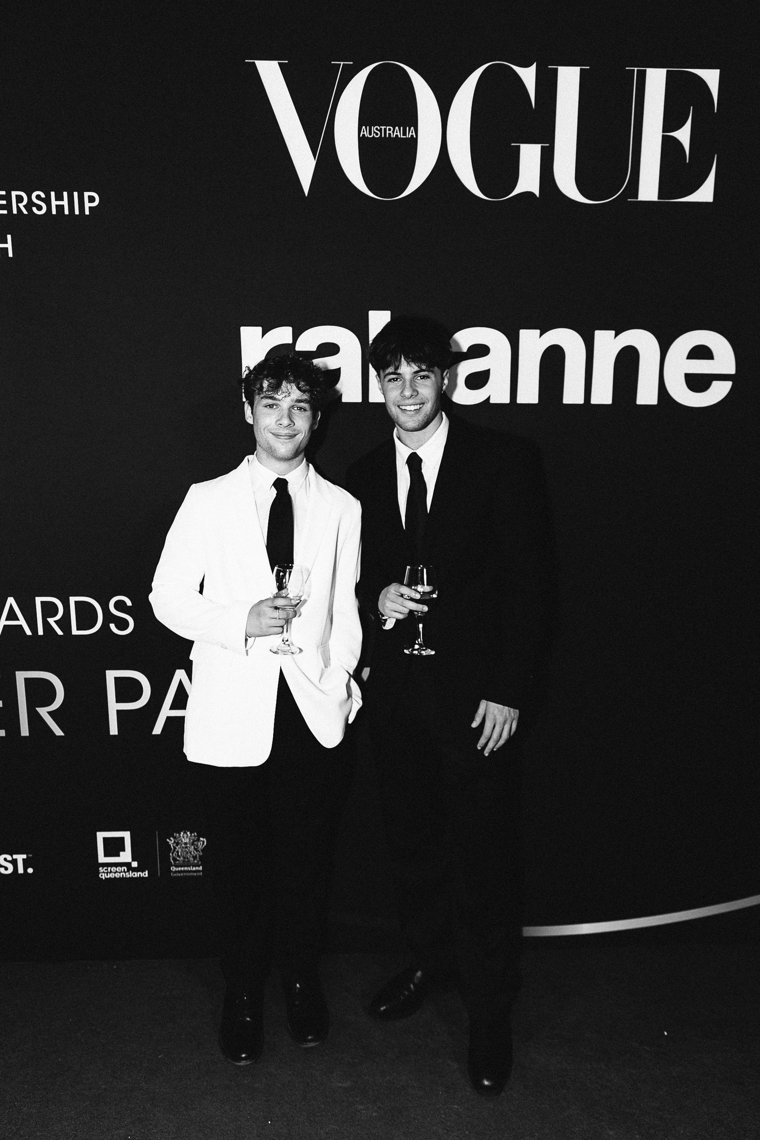 Black and white photos from a Vogue event showing attendees in formal attire.
