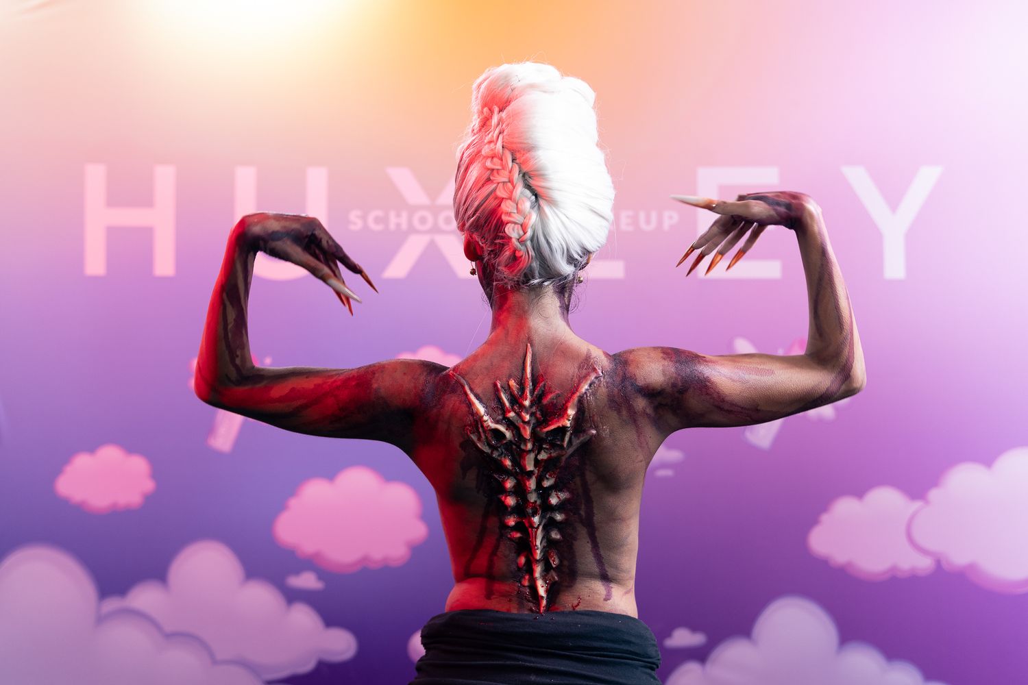 Silhouetted figures against colorful pink and purple gradient backdrop with 'HAPPY' text.