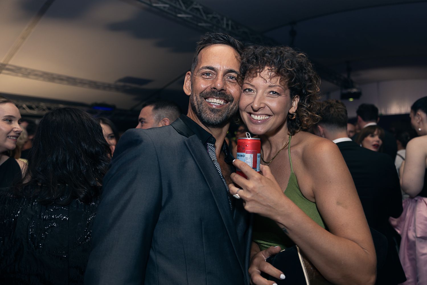 Candid party photos showing people laughing and enjoying themselves at a social gathering.