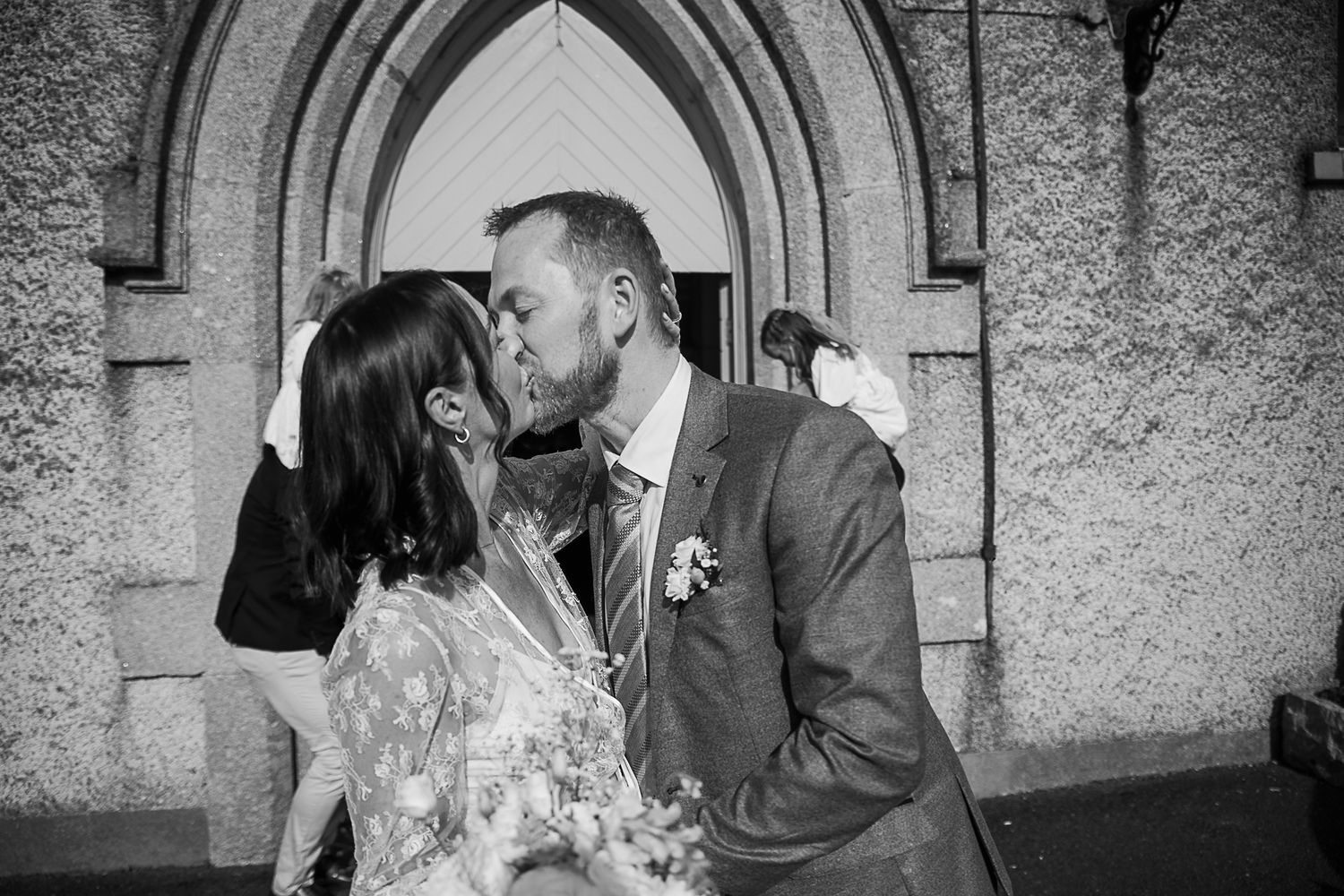 Black and white wedding photo sequence showing intimate moments between newlyweds.
