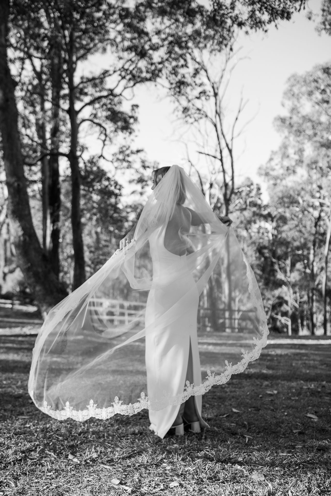 Black and white photos of bride twirling in her dress and veil outdoors.