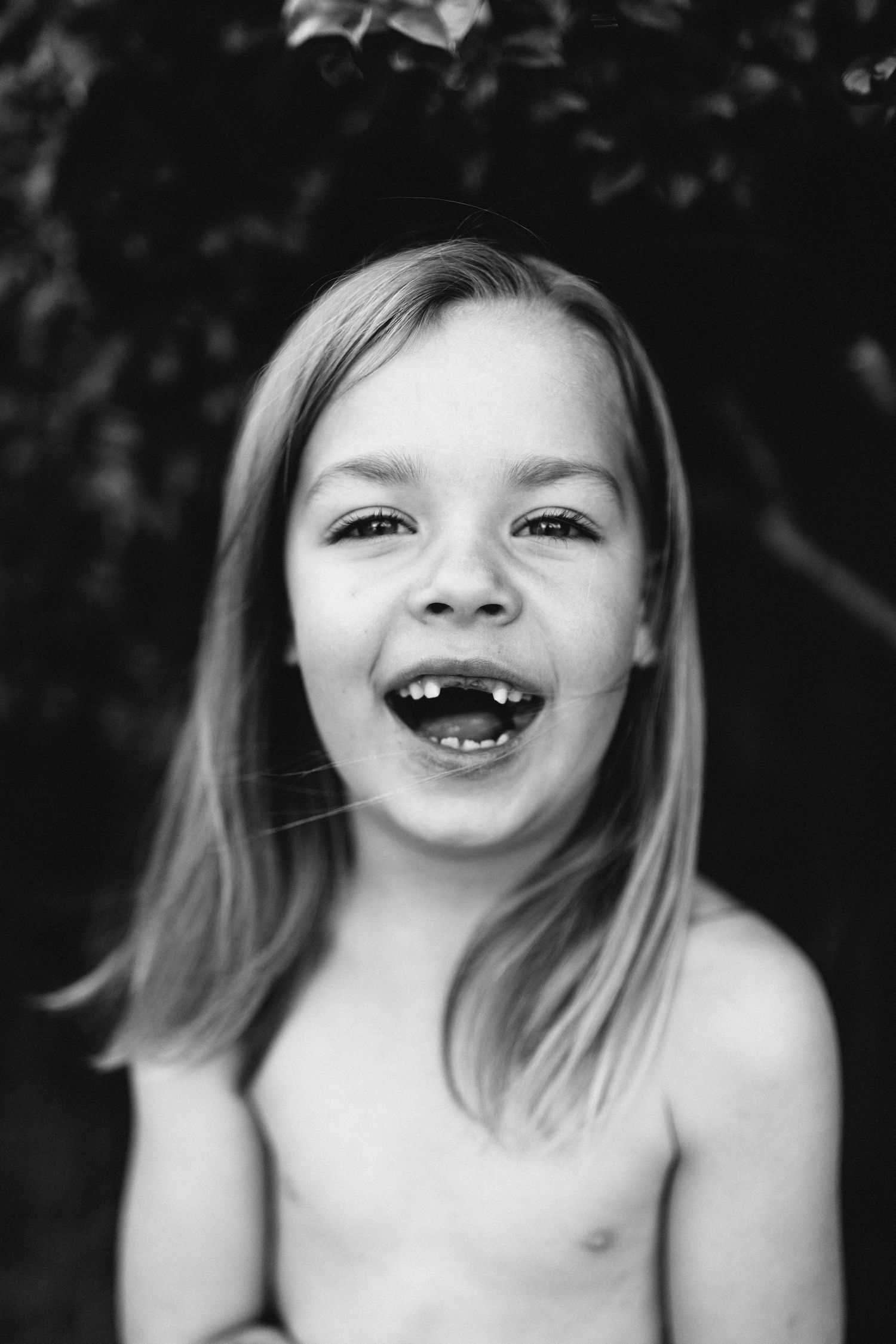 Black and white portrait sequence showing expressions of joy and laughter.