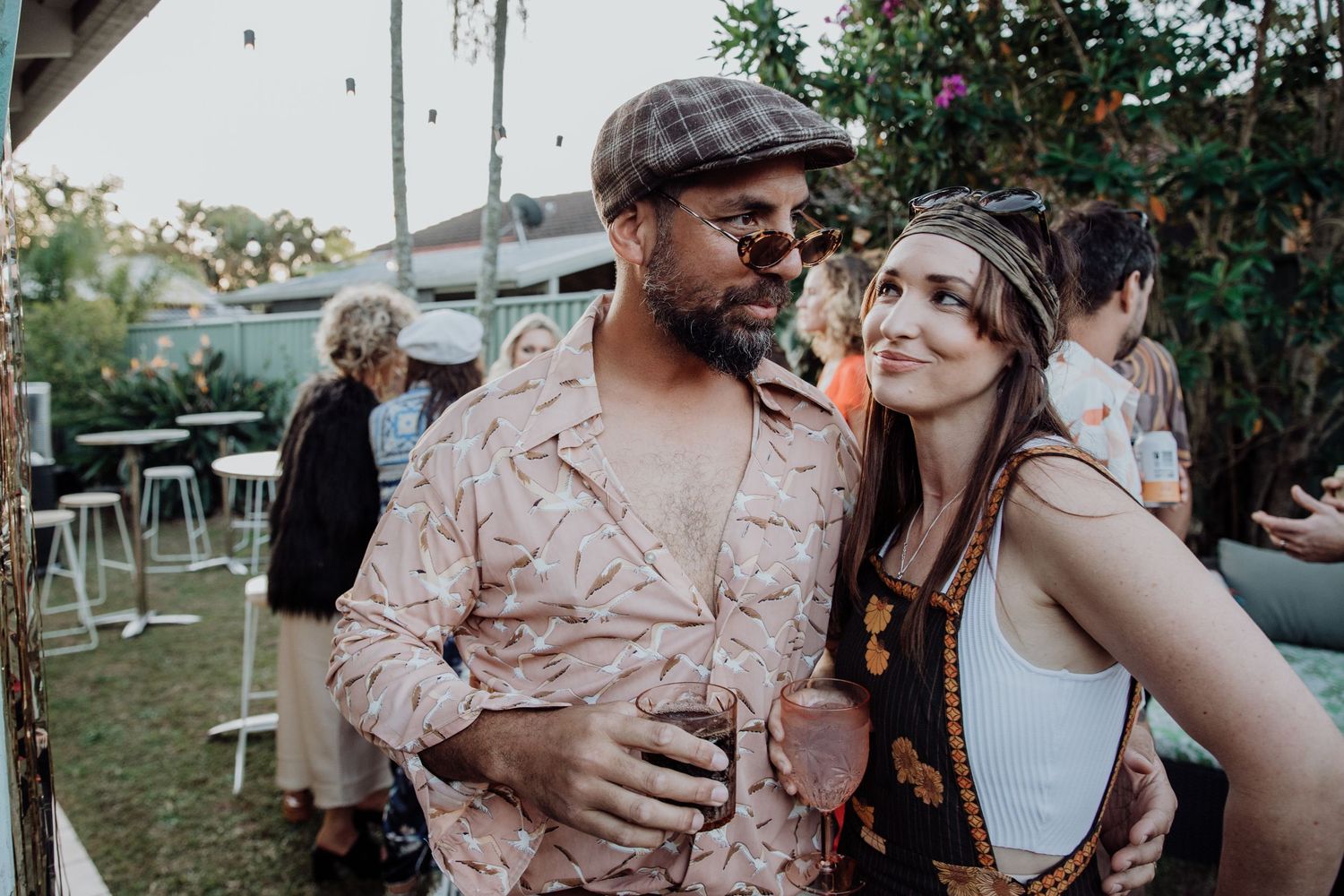 Candid outdoor party photos with couples embracing and dancing.
