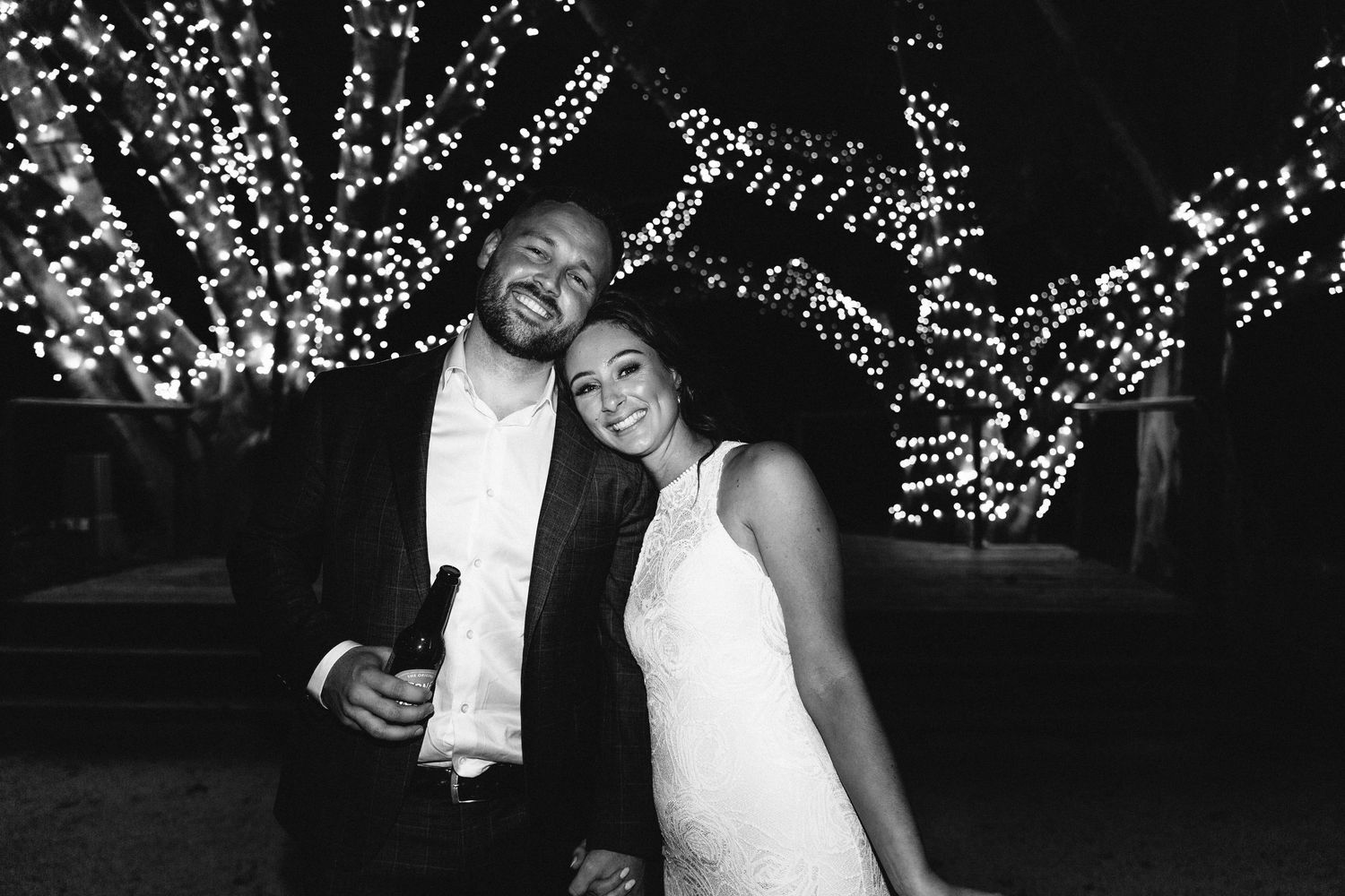 Romantic wedding photos with twinkling lights and elegant decor in the background.