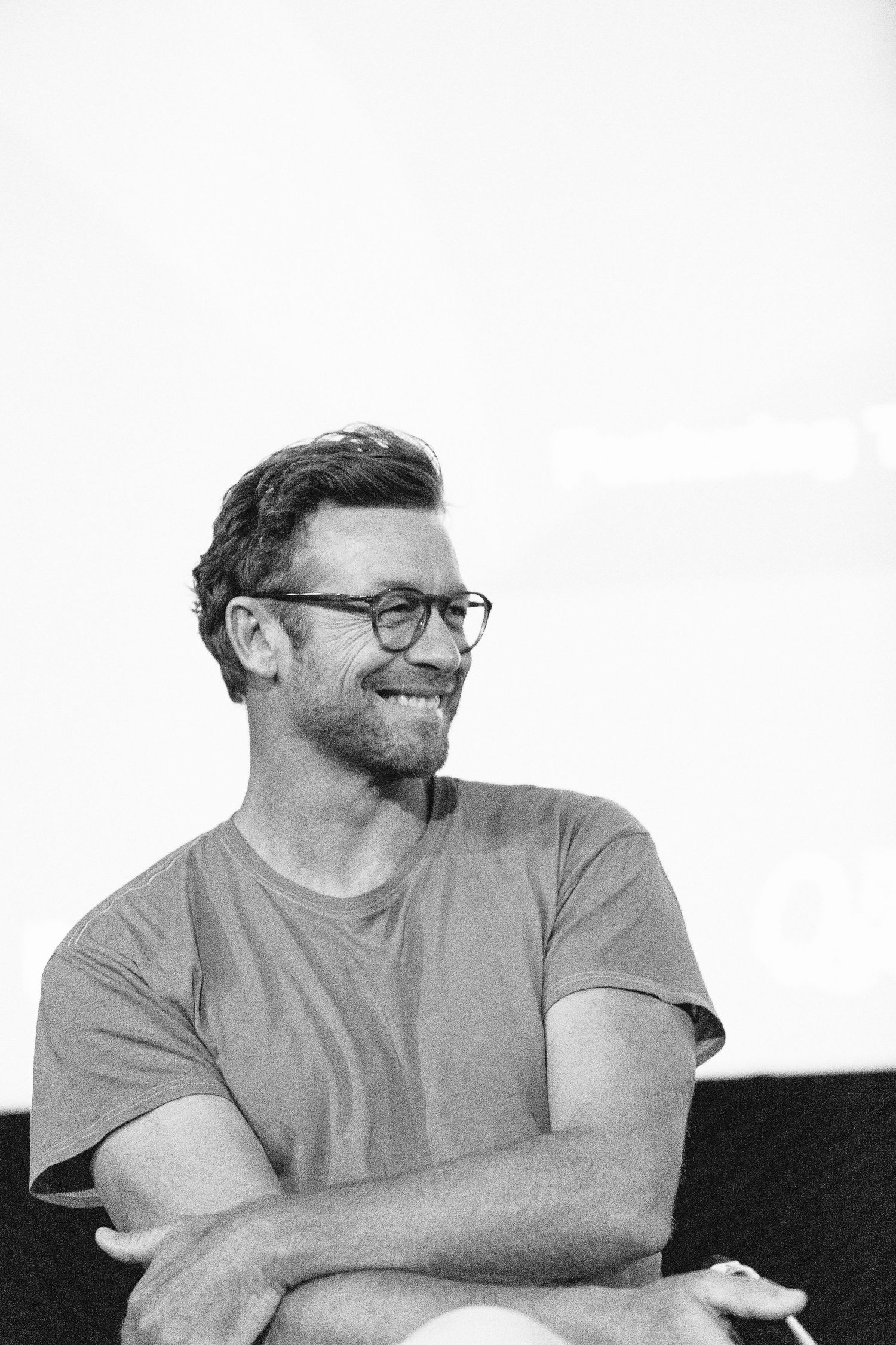 Black and white portrait series showing casual expressions and laughter.