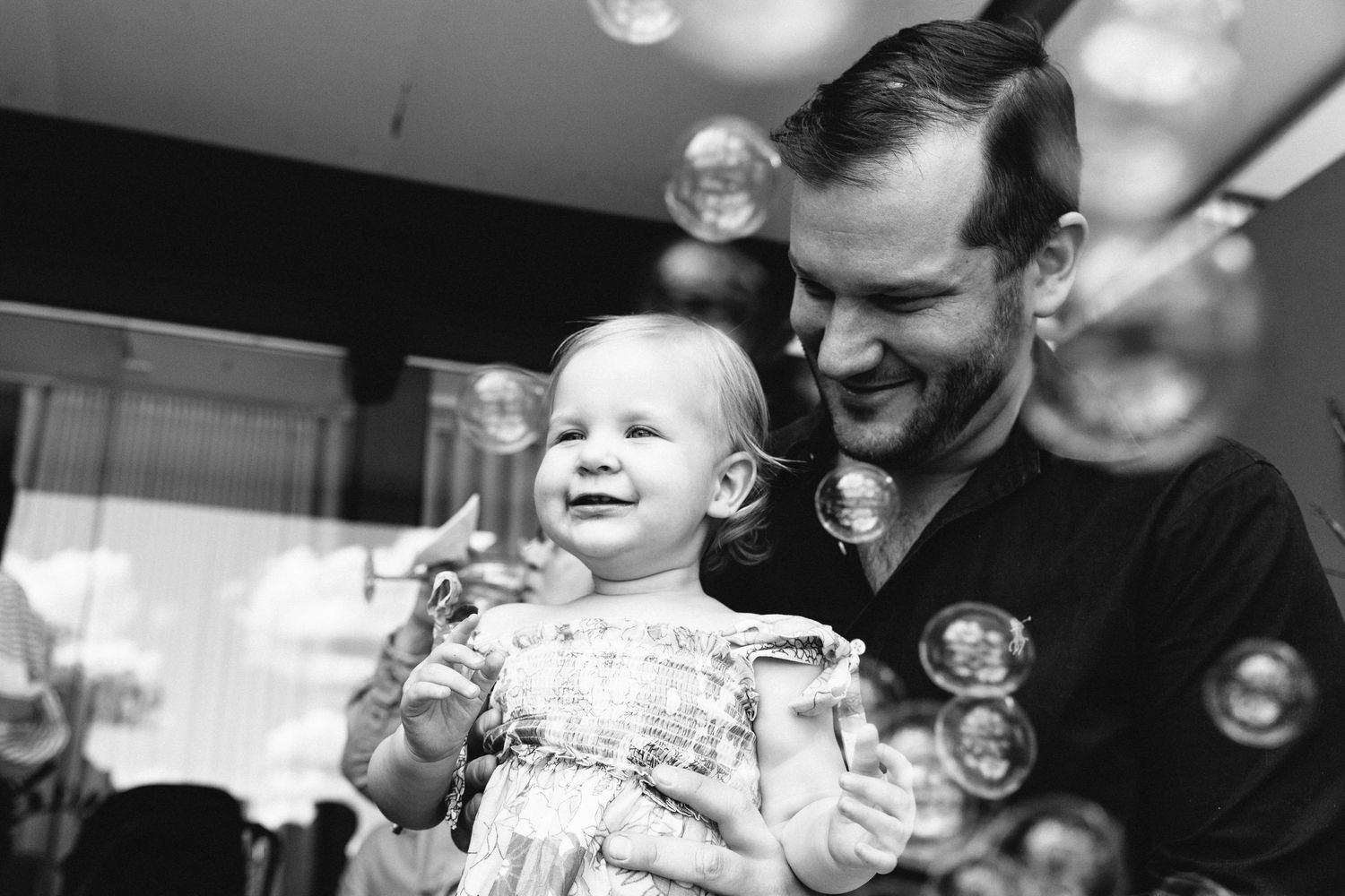 Black and white sequence of playful moments with soap bubbles creating a joyful atmosphere.