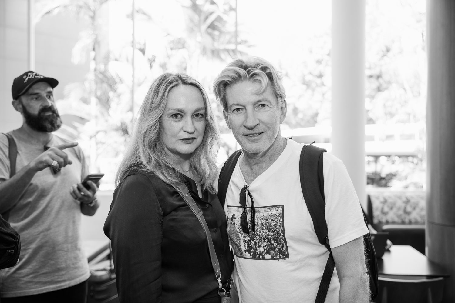 Black and white portraits of people in casual setting with white columns.
