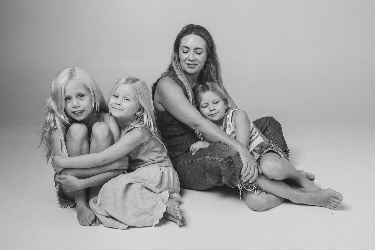 Black and white series of intimate family moments on light background.