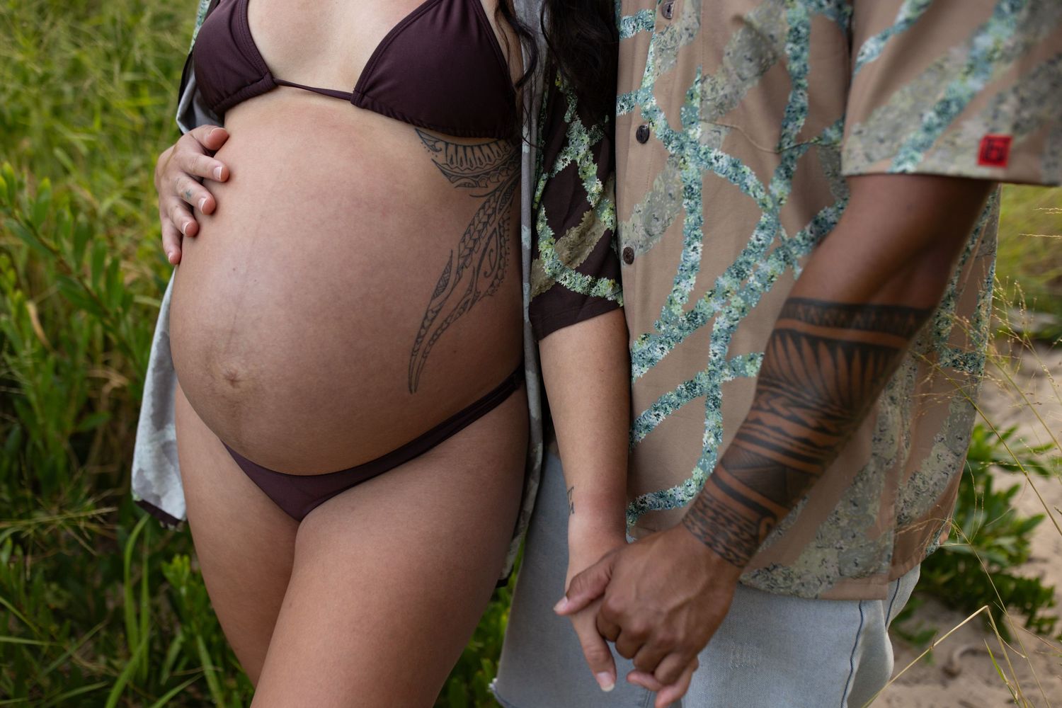 Close-up maternity photos showing a pregnant belly against a floral dress.