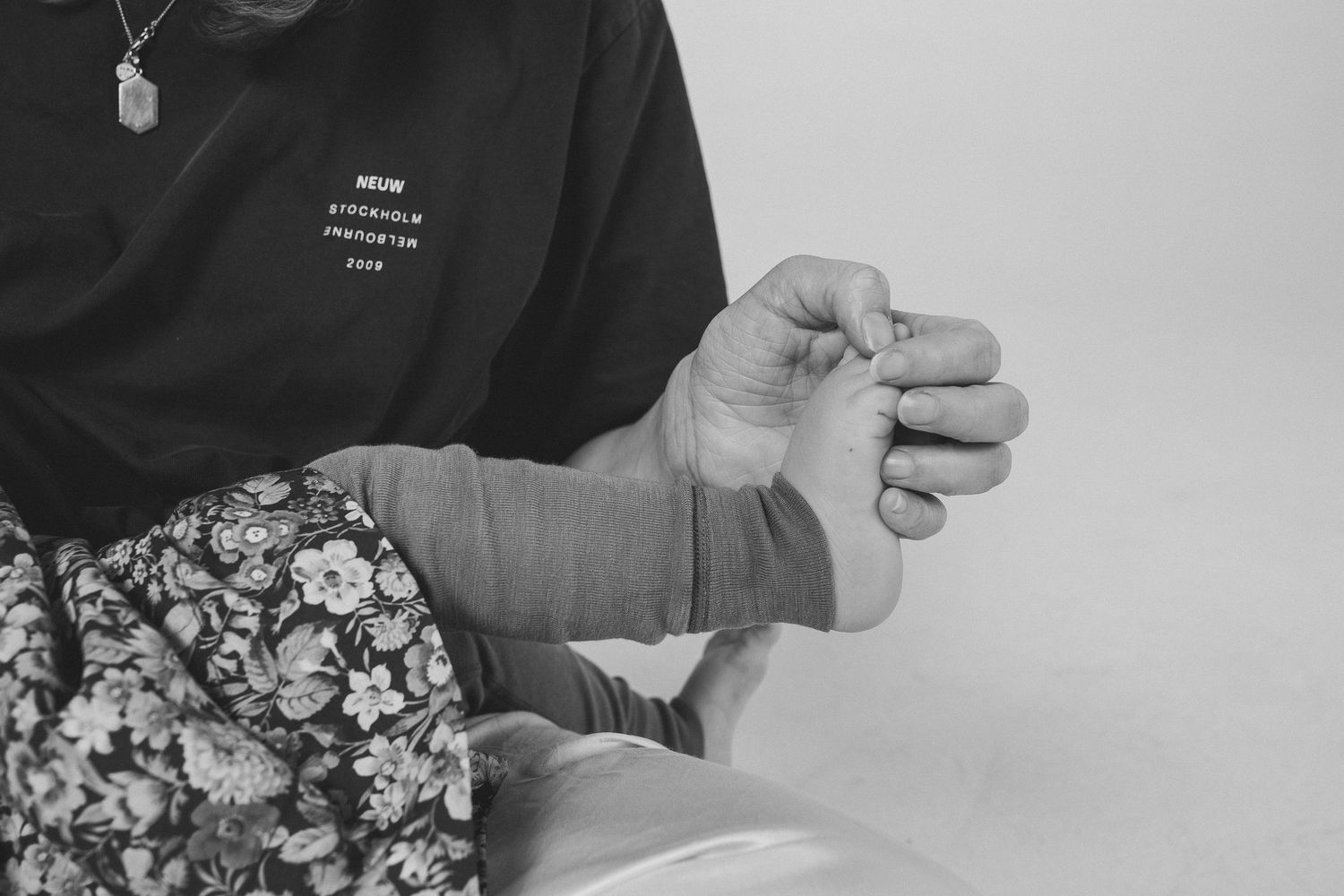 Close-up moments of affection captured in black and white studio setting.