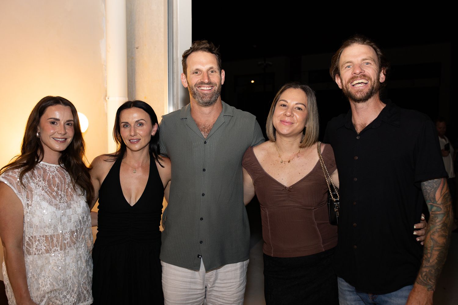 Group photo of people wearing formal attire at an evening event.