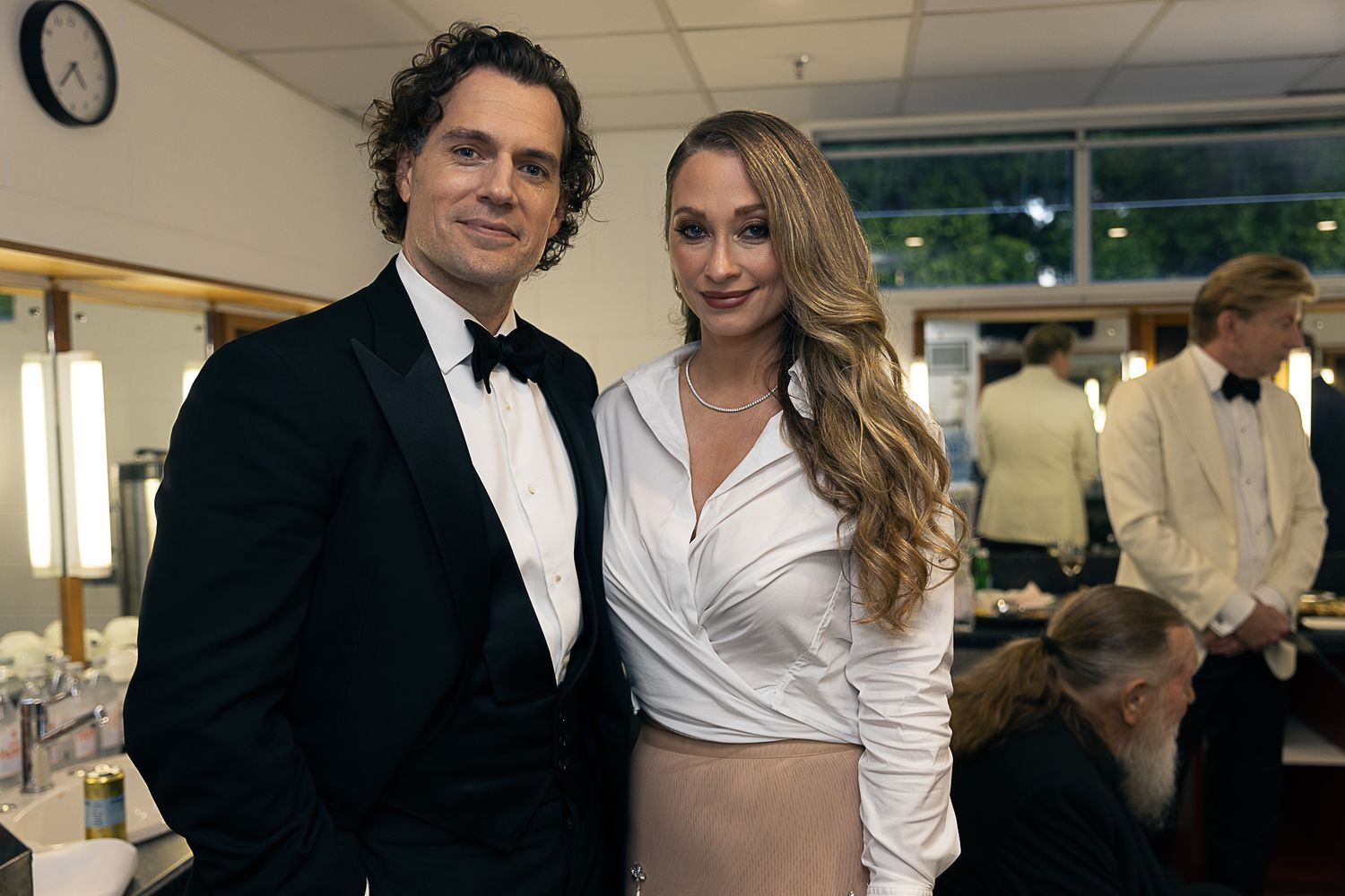 Formal couple posing together at elegant evening event.