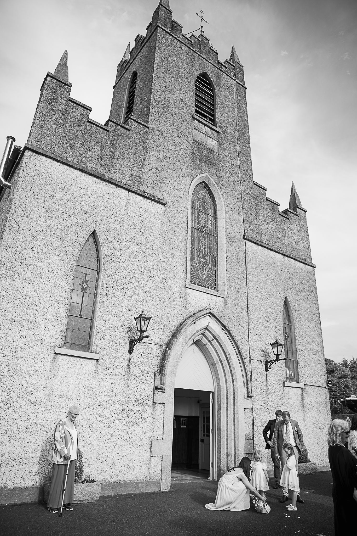 Gothic revival church exterior with stone facade and pointed arches.