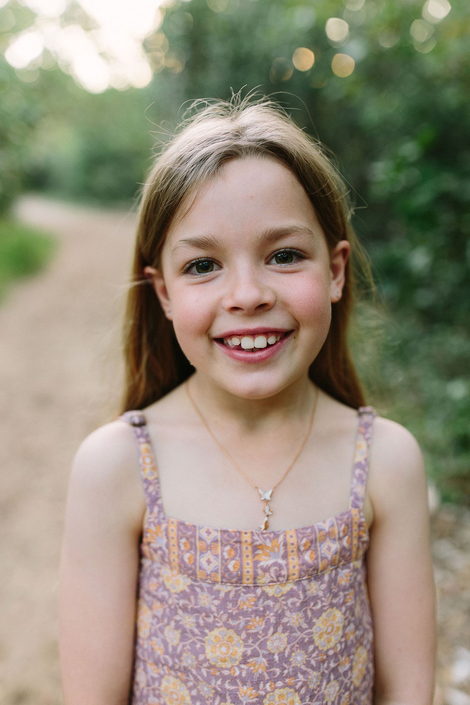 Series of candid expressions in a natural outdoor setting with soft bokeh background.