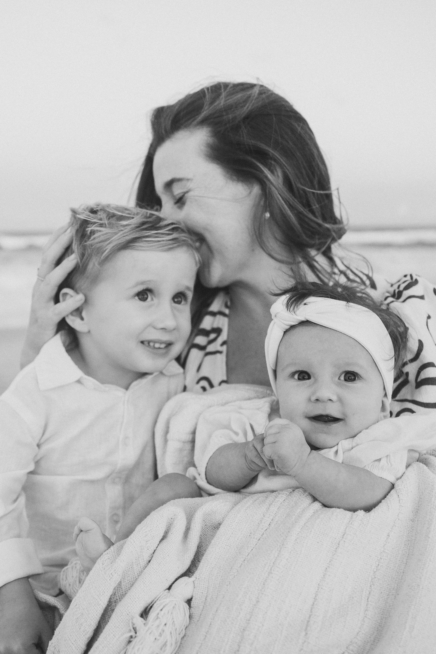 Intimate black and white portraits of parent and baby sharing tender moments.
