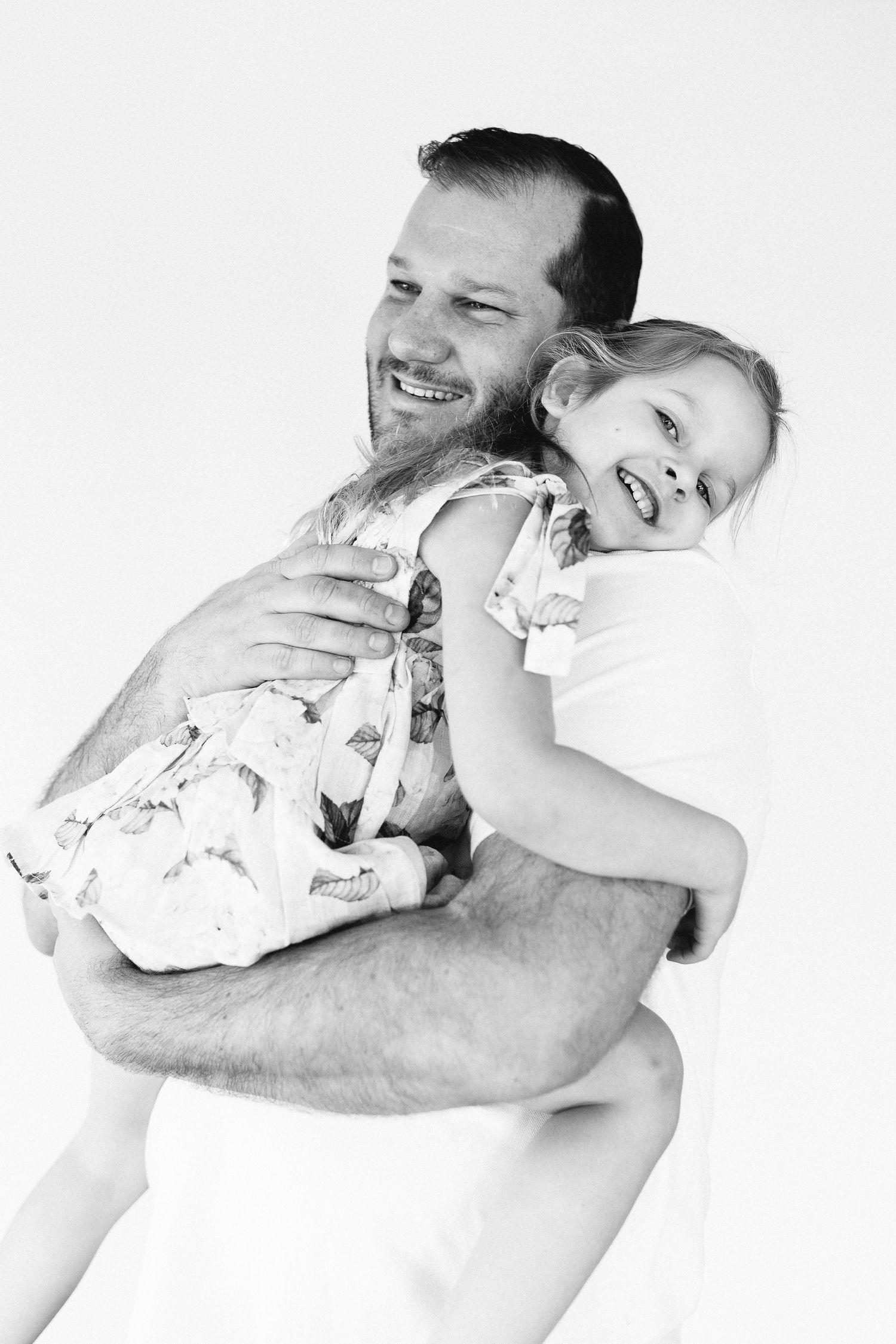 Black and white series showing joyful embraces against white background.