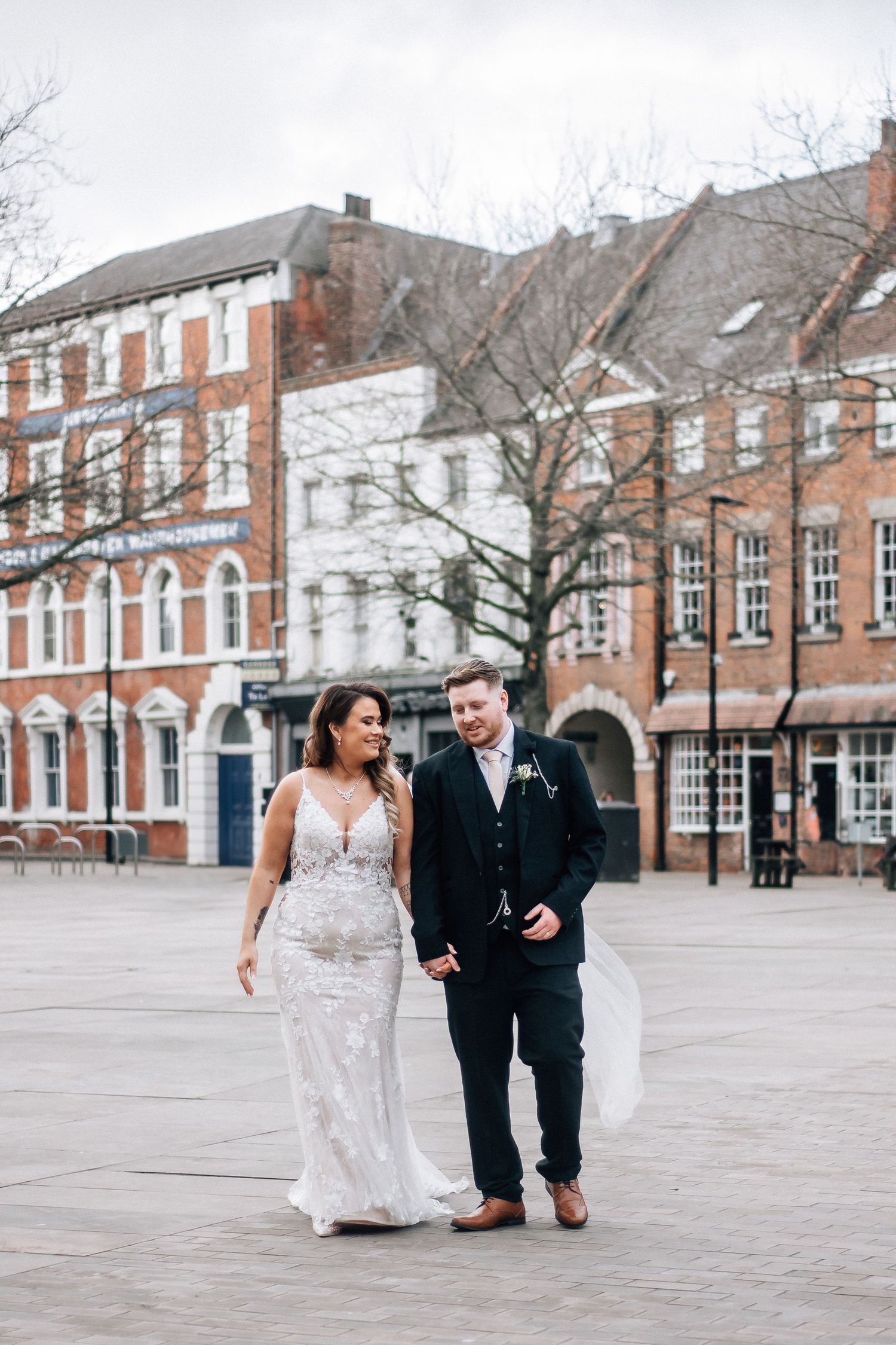 Bride and groom walking near Hull Trinity Church
