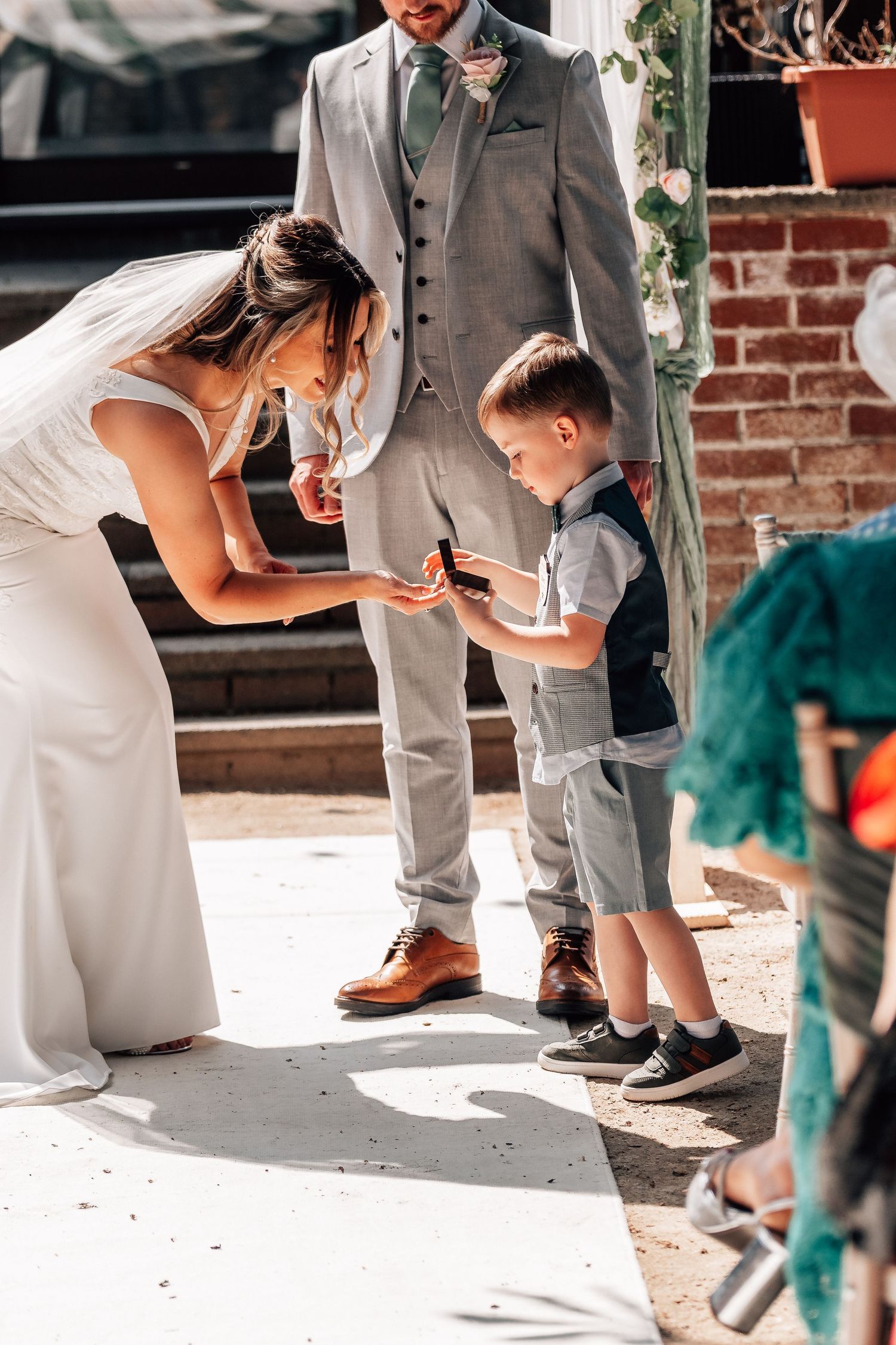 Bride taking rings from her son at Mercure Grange Hotel