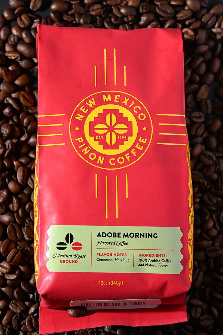 New Mexico Piñon Coffee bag featuring Adobe Morning blend surrounded by coffee beans.