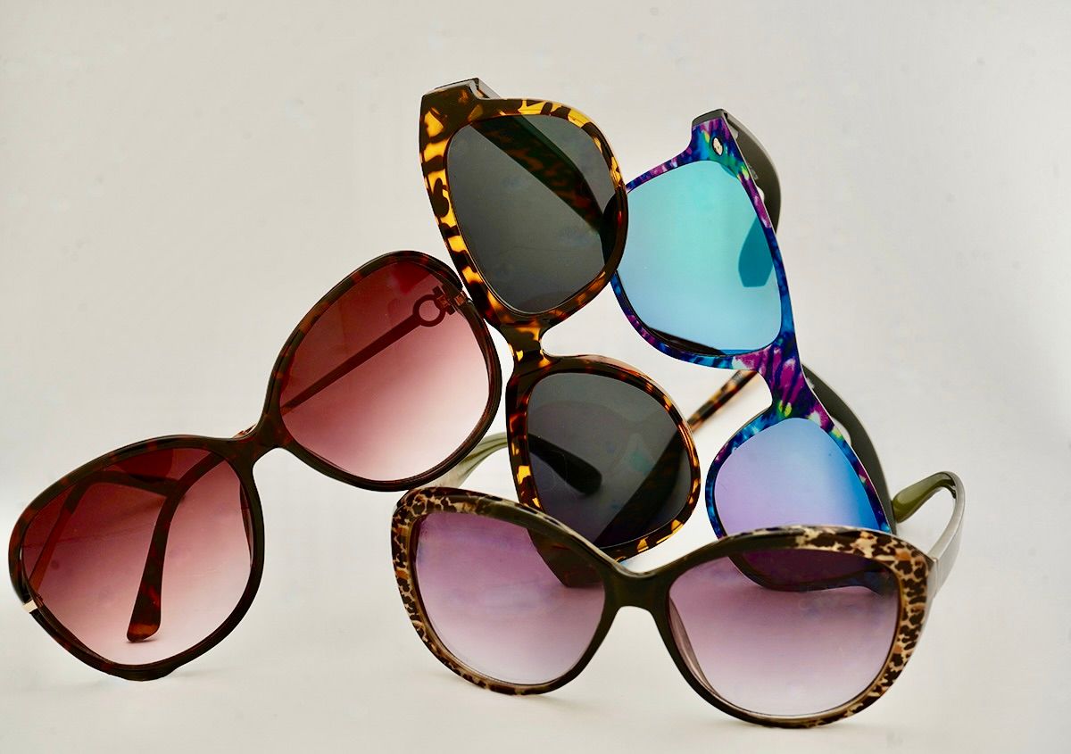 Collection of fashionable sunglasses with gradient lenses arranged in a row.