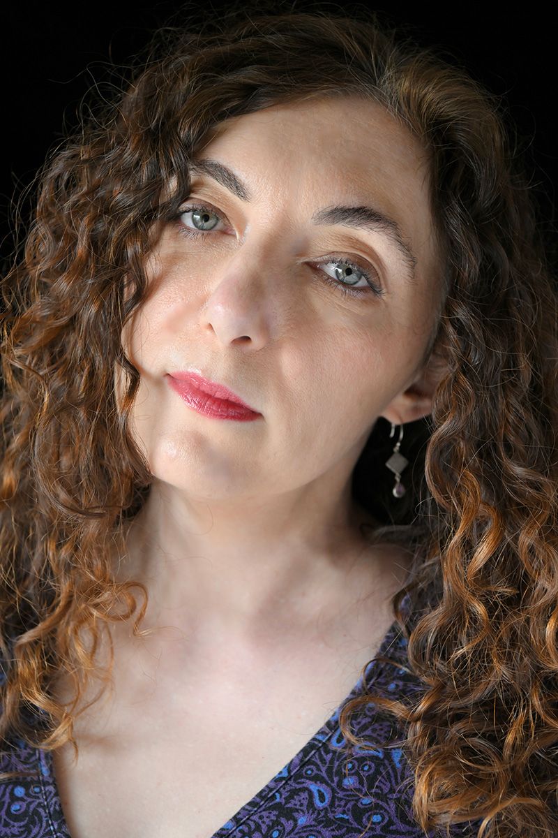 Artistic portrait series featuring curly hair and dramatic lighting against a dark background.
