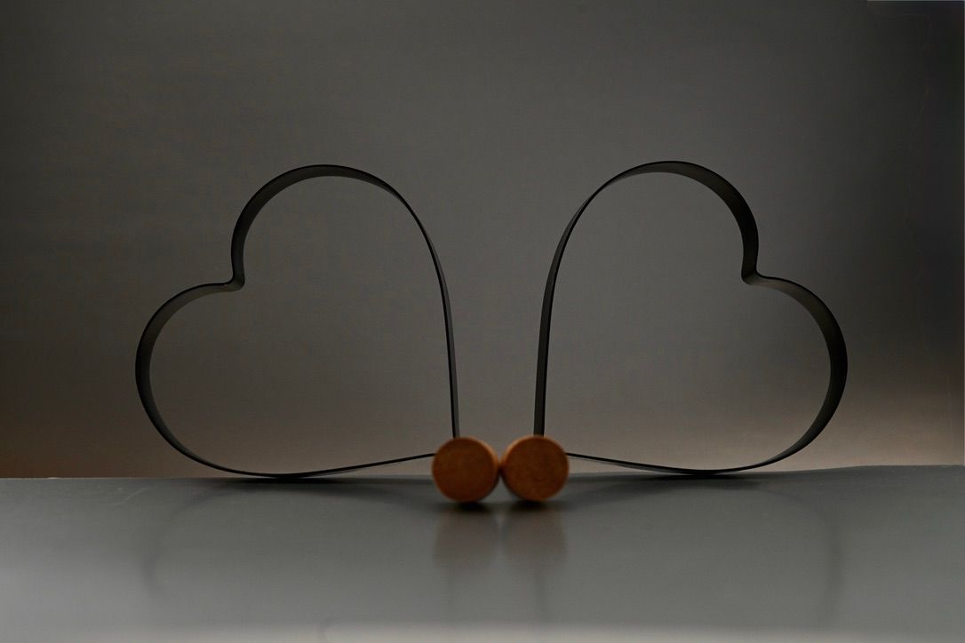 Heart-shaped pancake molds against a gray background.
