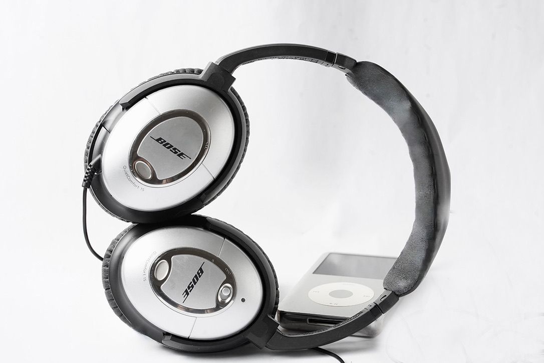 Minimalist black and white headphones arranged in artistic composition.