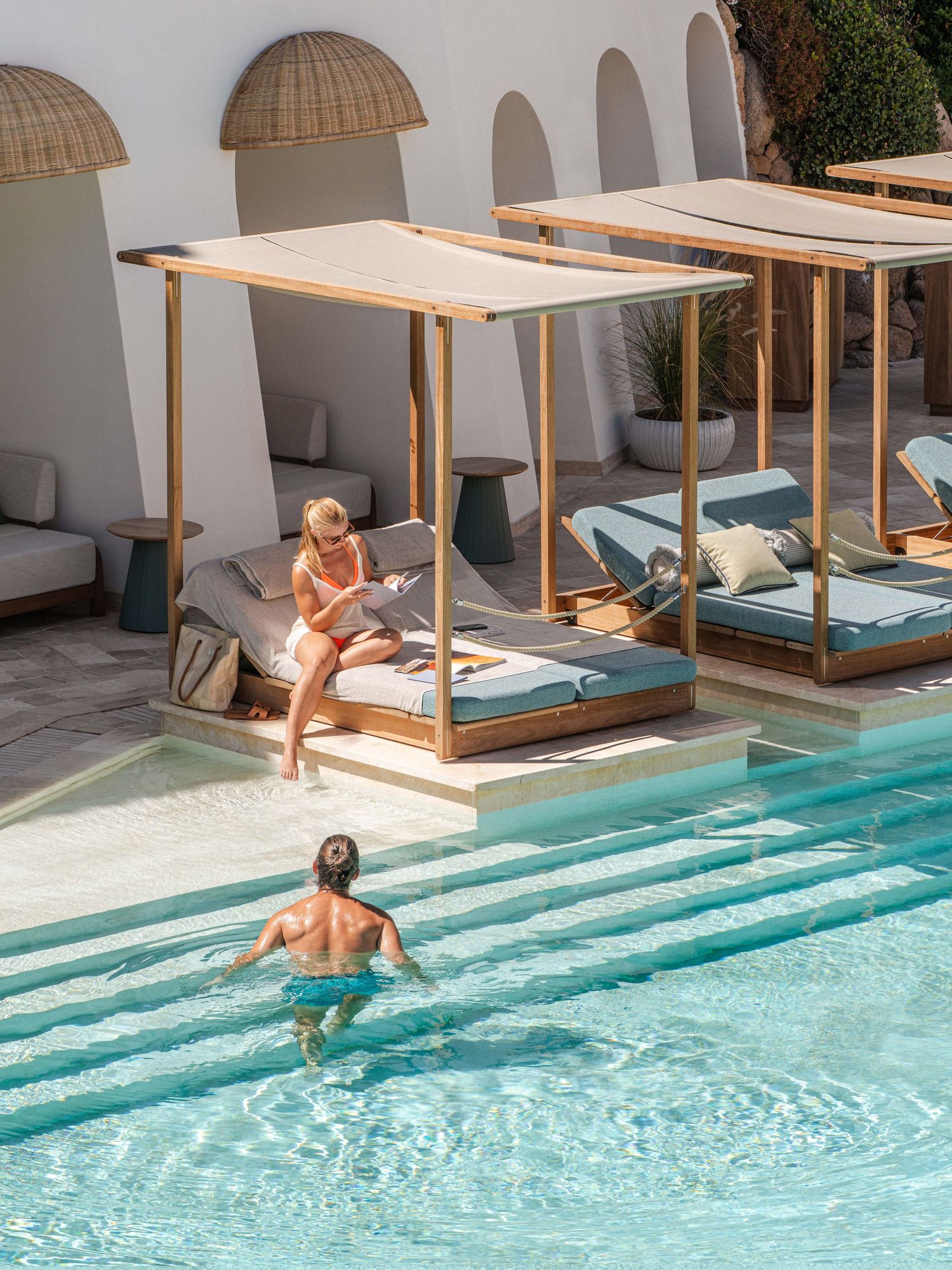 Resort poolside with private cabanas and crystal clear turquoise water.