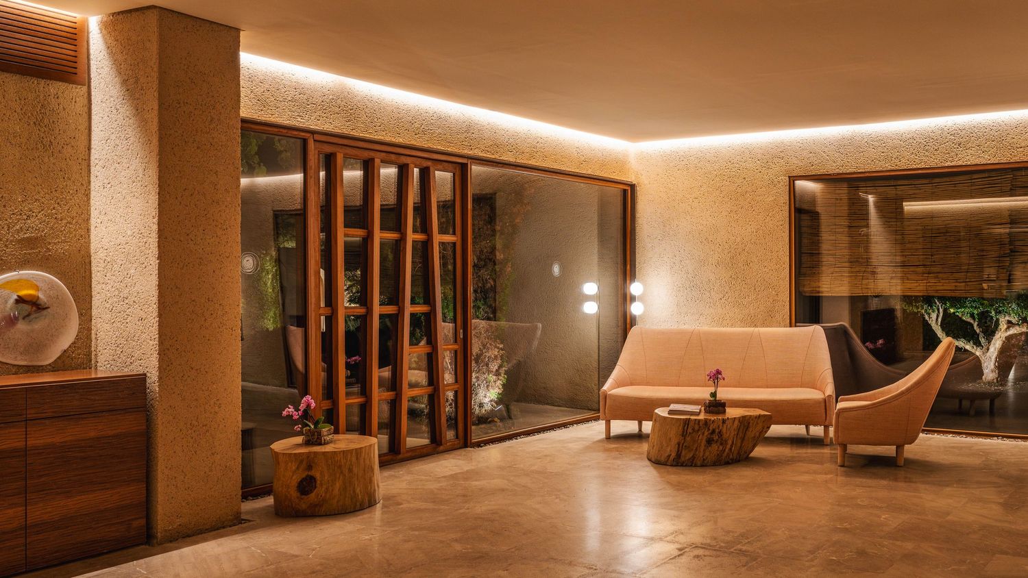 Elegant hotel corridor with wooden panels and recessed lighting design.