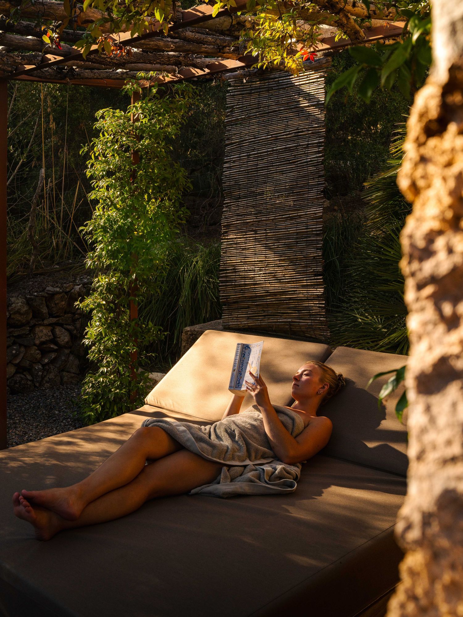 Peaceful daybed in a shaded garden setting perfect for afternoon relaxation.
