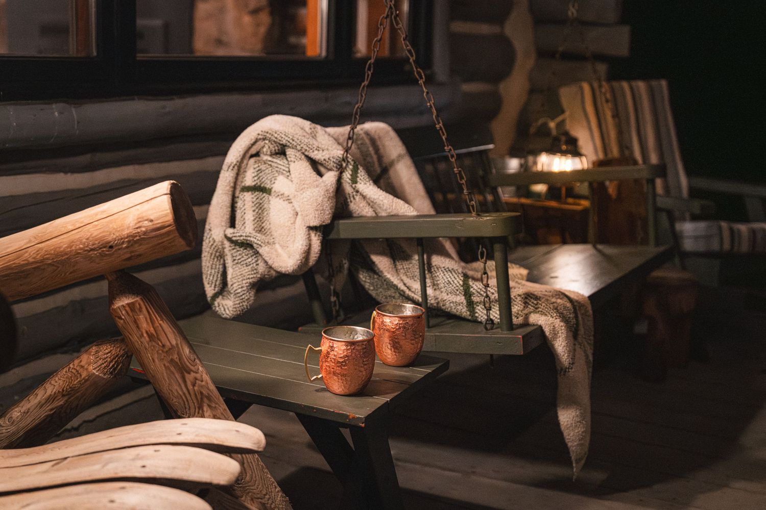 Rustic woodworking tools and vintage materials displayed on a dark wooden workbench in warm lighting.