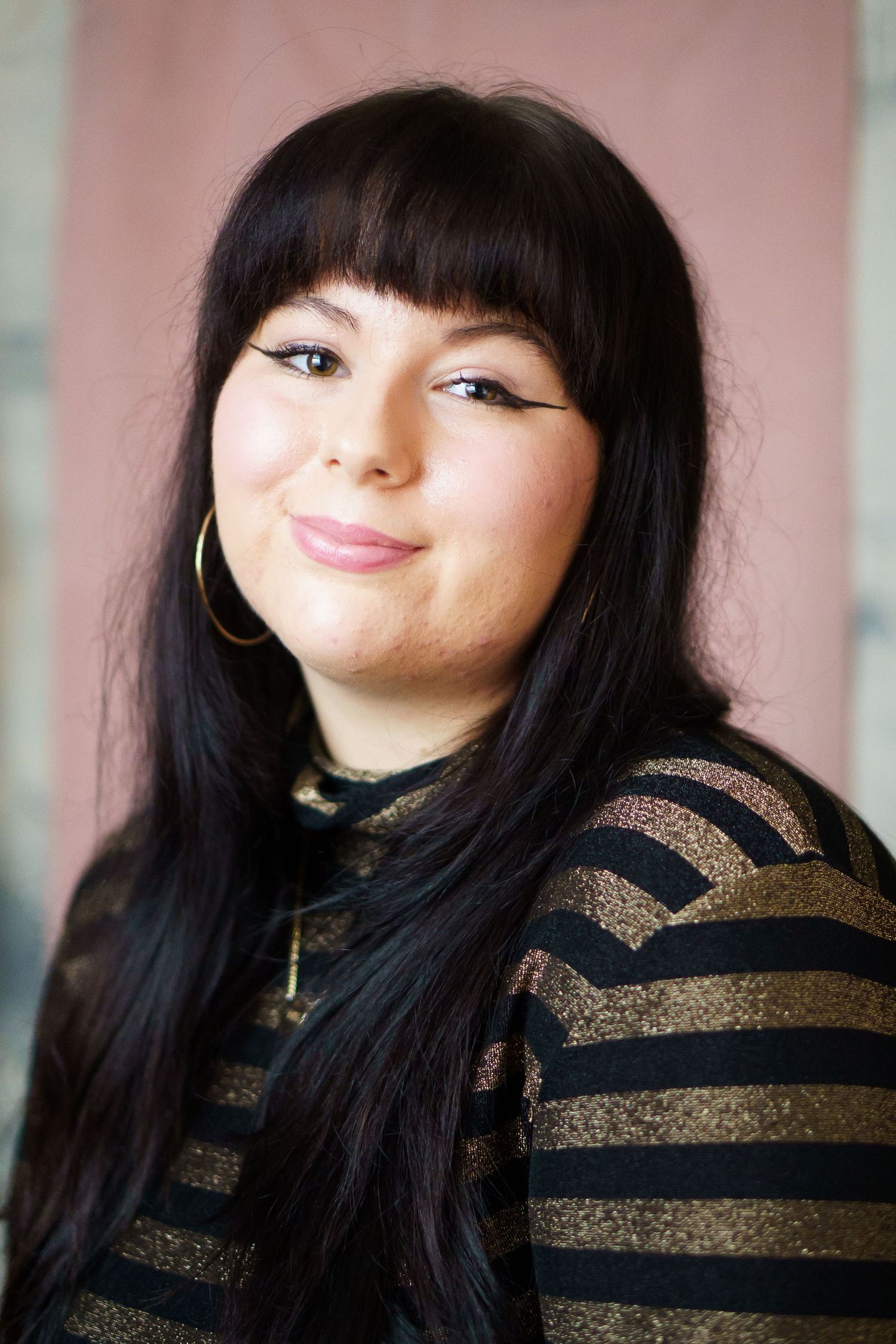 A series of five photos showing someone in a black and gold striped sweater making playful expressions.