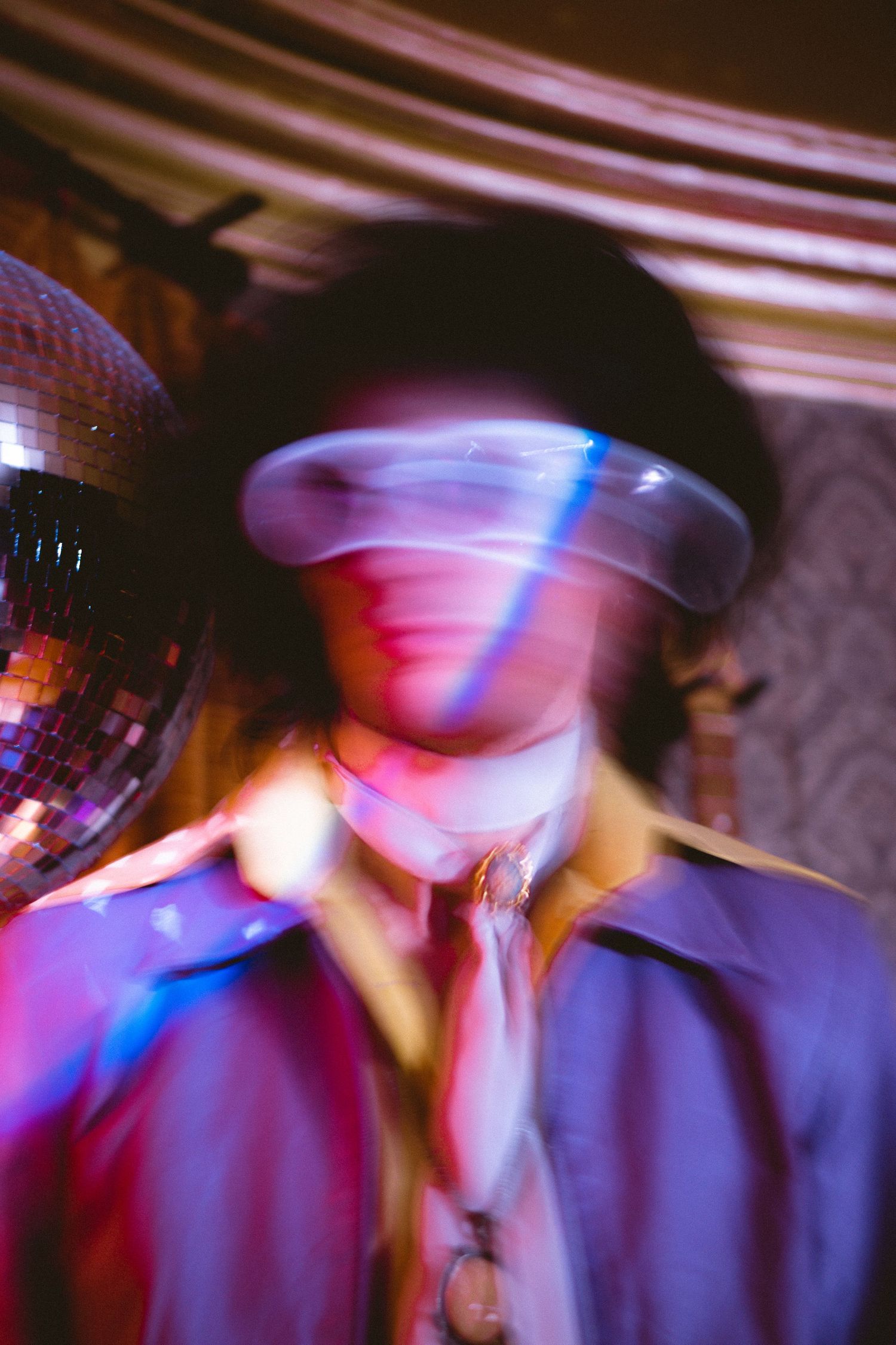 Artistic nightclub photo with motion blur and disco ball lighting effects.