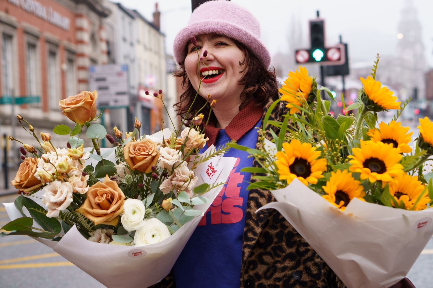 Colorful bouquets of fresh flowers arranged in paper wrapping at an outdoor market display.
