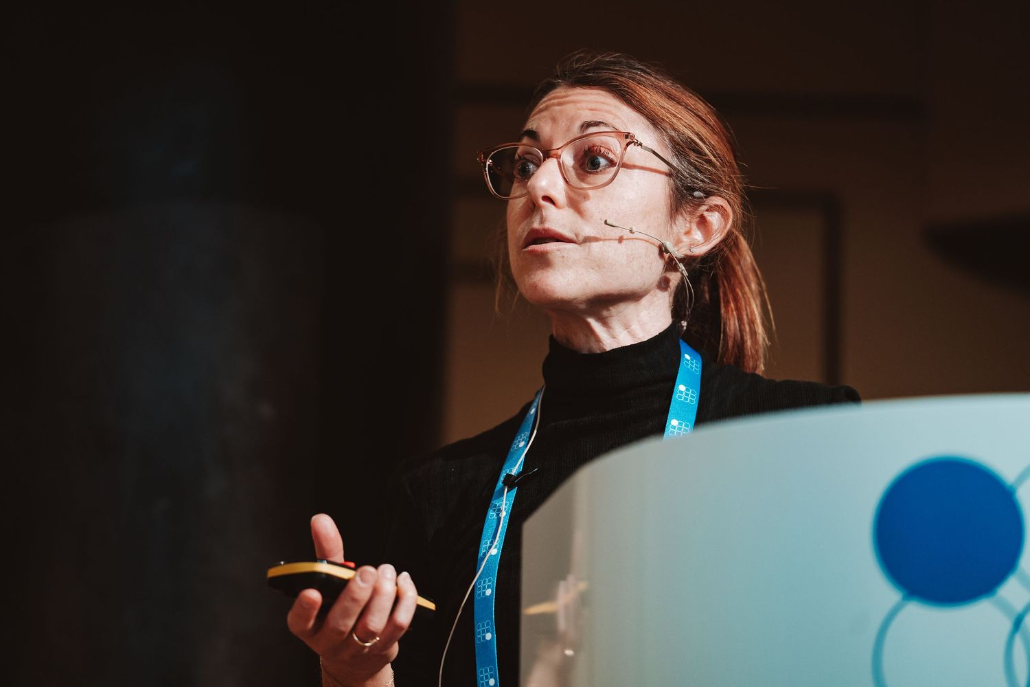 A sequence of photos shows a person with glasses in dramatic lighting holding a blue butterfly against dark backgrounds.
