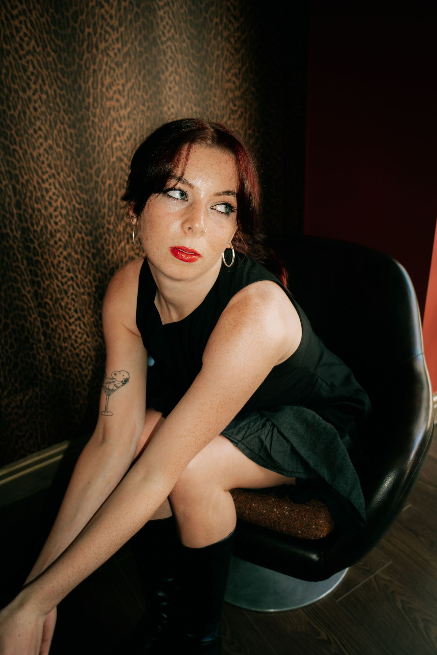 Artistic portrait series against leopard print backdrop featuring dark clothing and red lipstick.
