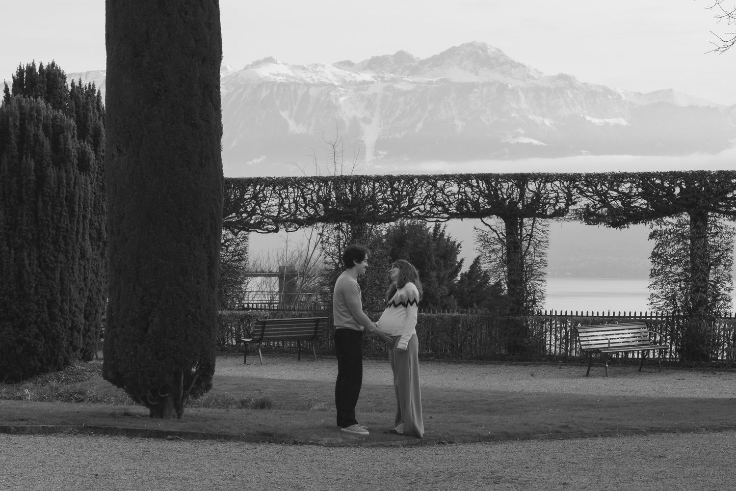 Black and white photo of an expecting couple in the distance, artistic and emotional pregnancy session