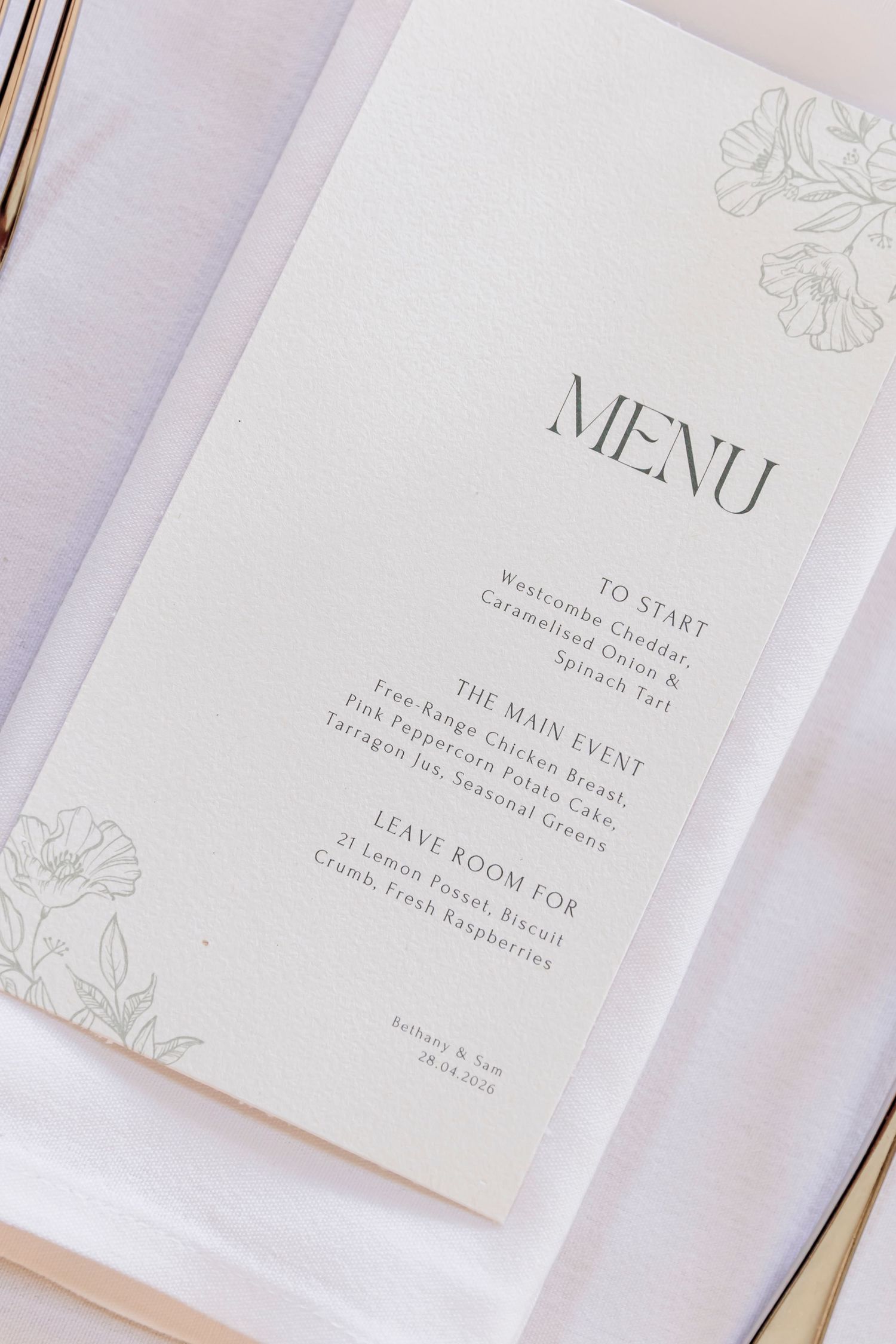 Elegant wedding menu card with floral design listing starter, main course, and dessert options on white background.