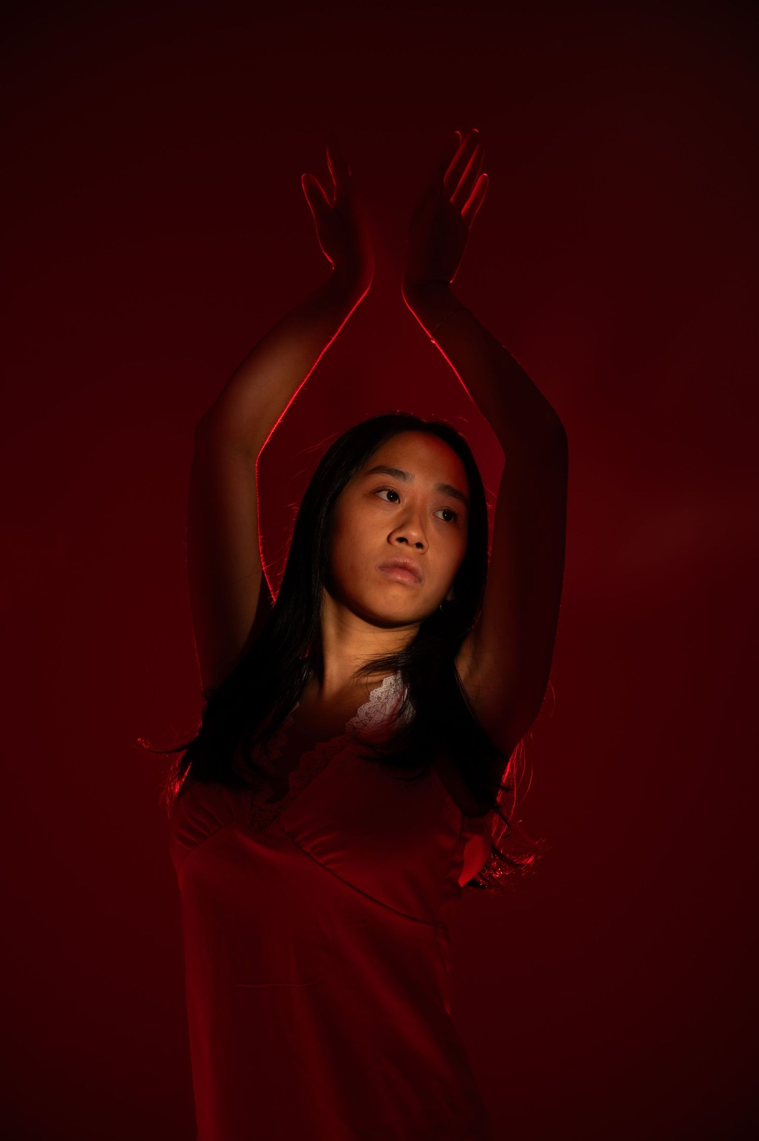 Dramatic dance poses captured in deep red lighting showcase artistic movement and expression.