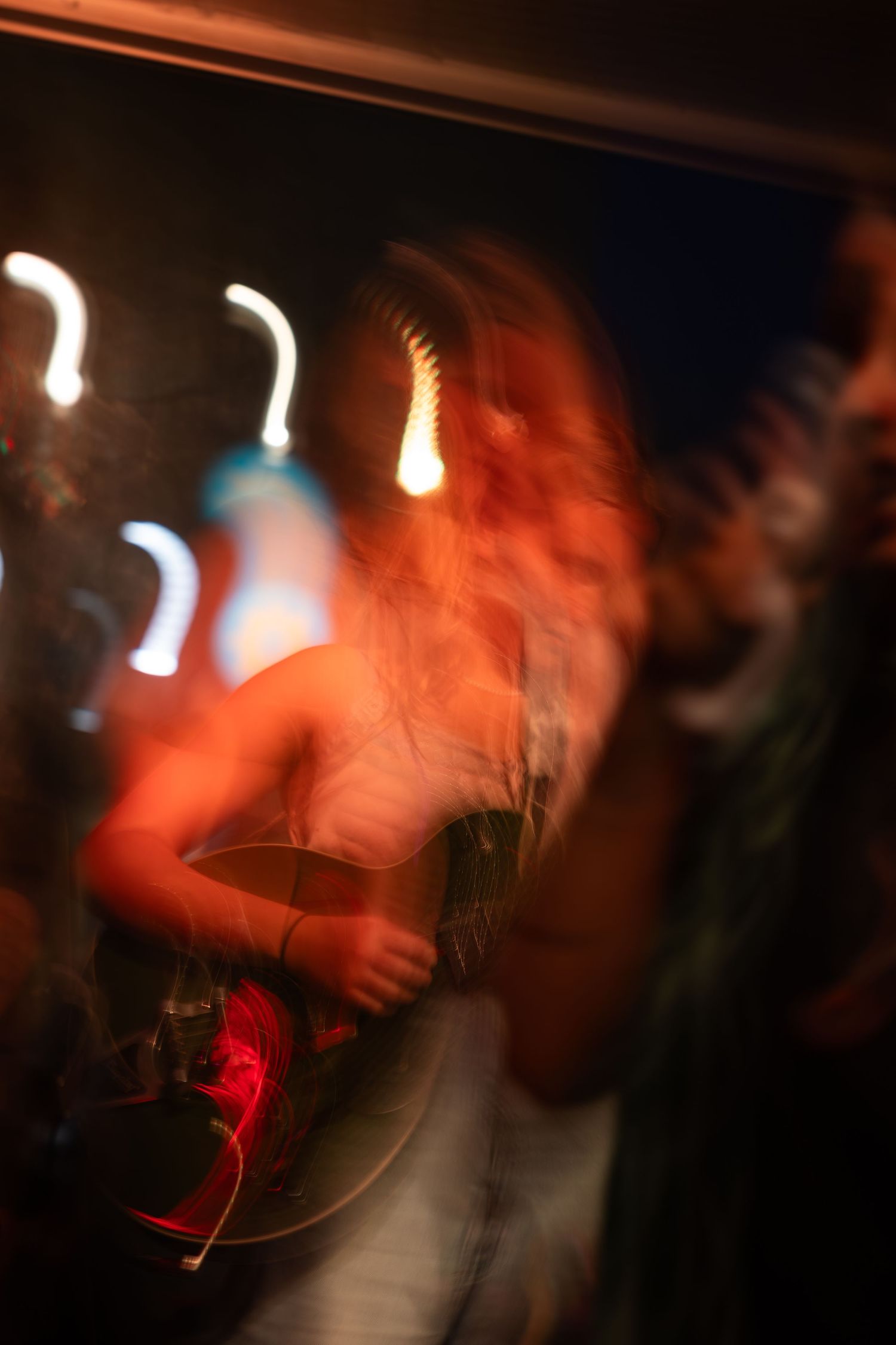 Motion-blurred concert scene with glowing lights creating an atmospheric nightclub ambiance.