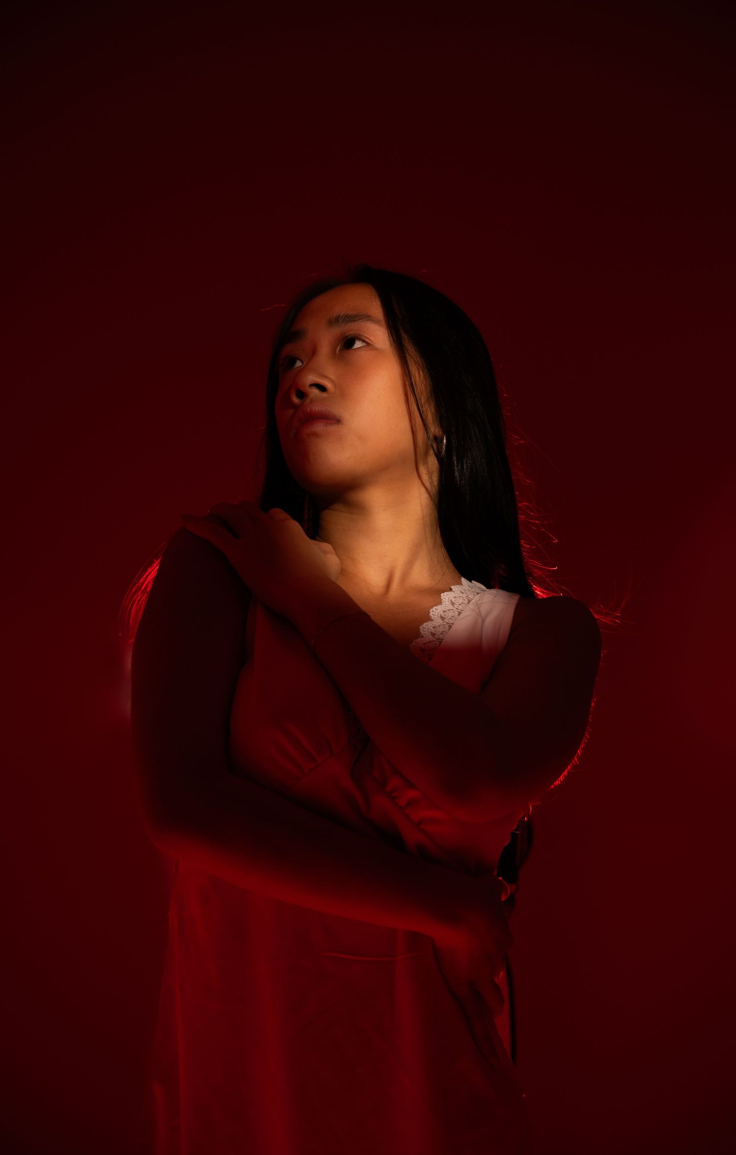 Dramatic red-lit portrait series showing artistic movement and expression.
