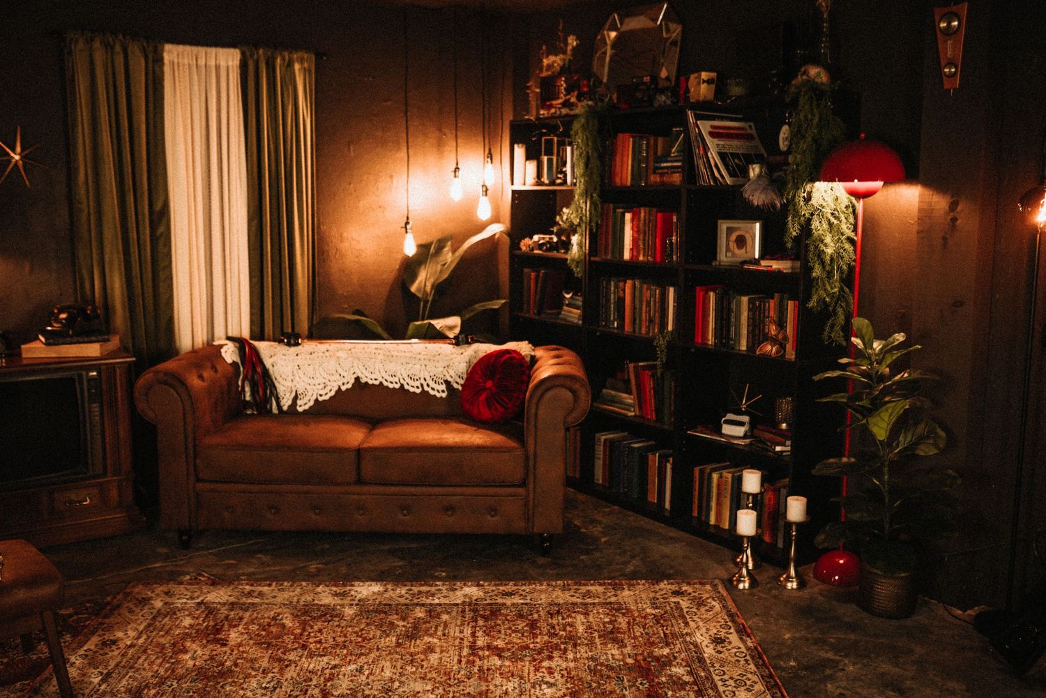 Cozy reading nook with bookshelves, warm lighting, and a comfortable armchair creates an inviting atmosphere.